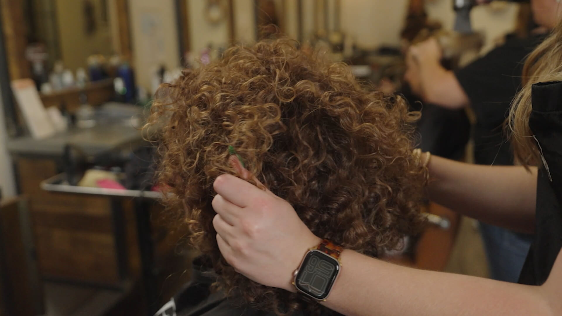 A photograph of frizzy hair being styled.