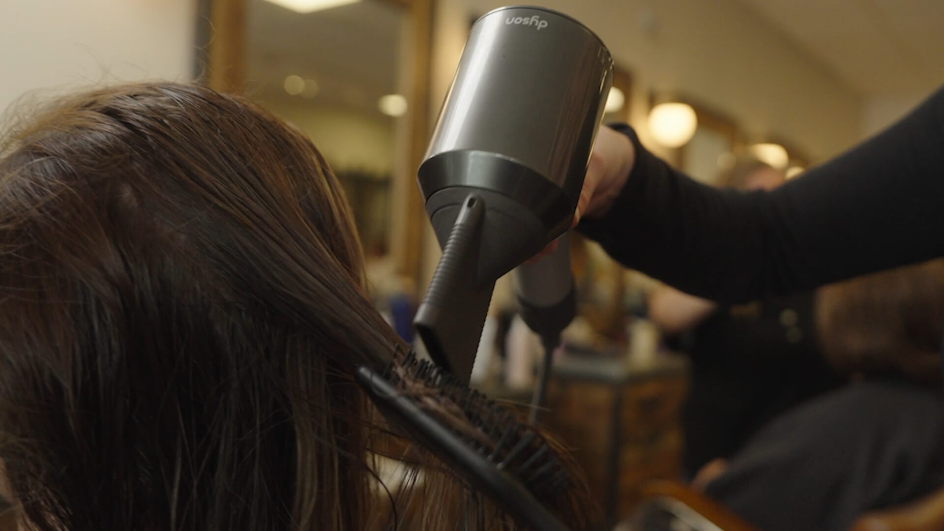 A photograph of hair being blow dried.